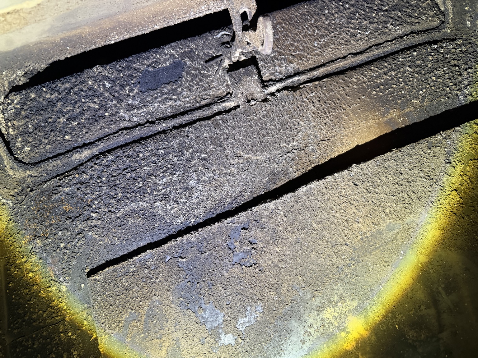 Soot deposits inside a fireplace smoke chamber